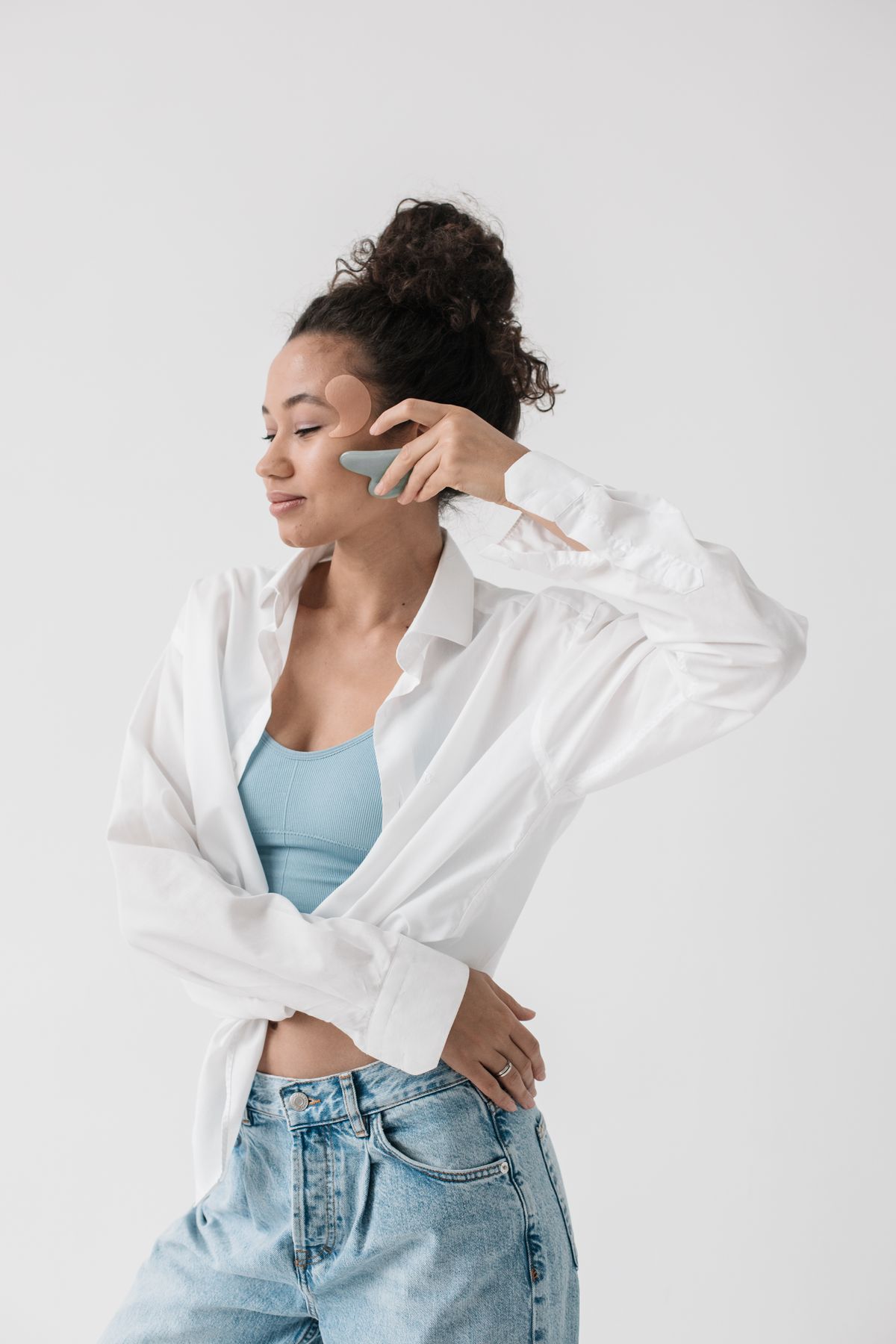 Flacidez facial: fotografía editorial de gua sha facial aplicado sobre la piel